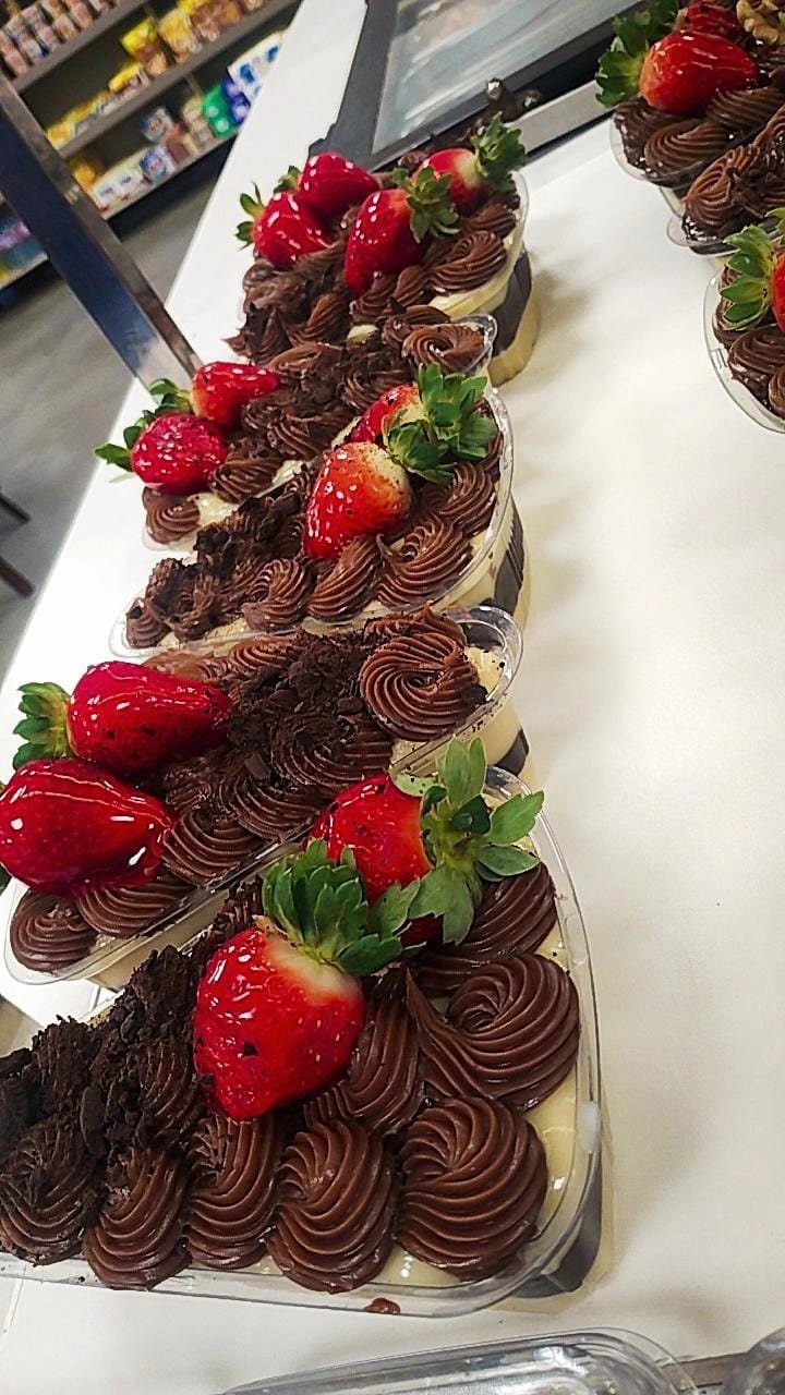Chocolate cups piped with ganache and topped with fresh strawberries